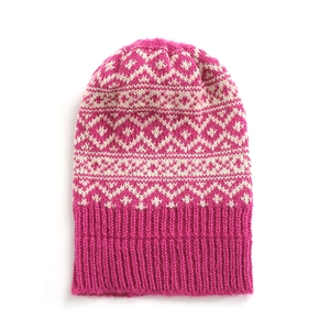 Detail of fuchsia knit beanie with white geometric jacquard pattern and ribbed cuff