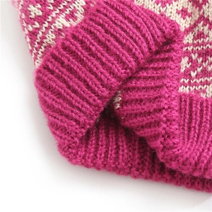 Detailed close-up of pink and beige diamond knit pattern on a warm winter beanie hat