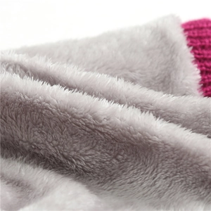 Macro detail of soft grey faux fur lining and magenta knit texture of the neck warmer