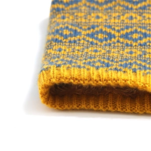 Close-up of geometric knit neck warmer with thick warm brown faux sherpa lining detail
