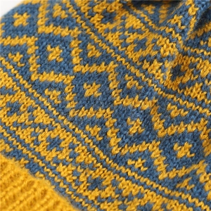 Close-up of dual-tone knit texture showing diamond pattern and yellow blue yarn details
