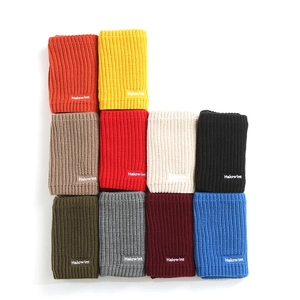 Detail of multi-color knitted neck warmer collection with Halowint brand labels