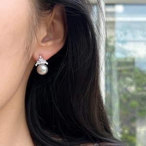 Elegant grey pearl crown earrings with micro-pave cubic zirconia on an Asian female model