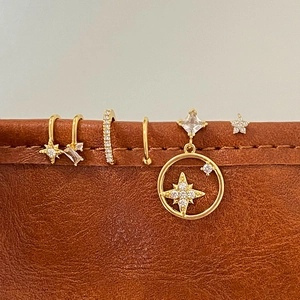French style gold ear cuff set with star motifs and zircon stones on leather