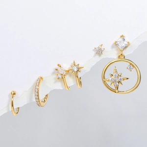 Macro shot of French style gold ear cuffs with star motifs and sparkling zirconias