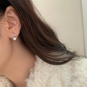 Elegant silver teardrop pearl earrings with minimalist vintage design on model
