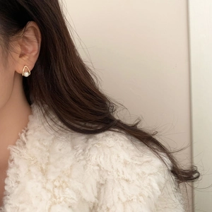 Minimalist gold triangle pearl stud earrings shown on model for elegant daily wear