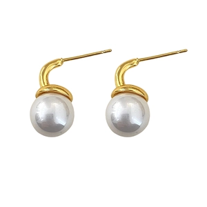 Elegant gold drop earrings with lustrous white pearls on a minimalist polished metal hook