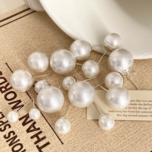 Elegant set of assorted white pearl stud earrings on a vintage aesthetic background