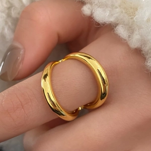 Polished gold adjustable open ring showing smooth metallic finish on fingers