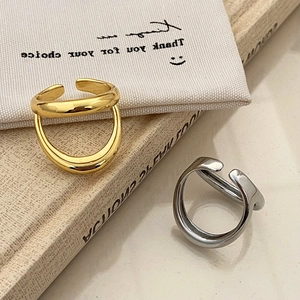 Minimalist double-layered open rings in gold and silver finish with polished metal texture