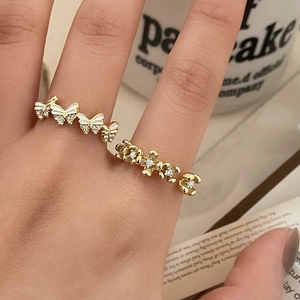 Adjustable gold butterfly rings with white enamel and sparkling crystals on open band