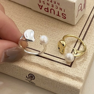 Minimalist open freshwater pearl ring set in gold and silver finish with polished metal