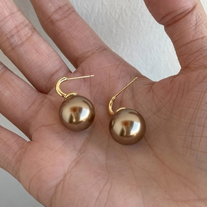 Elegant gold hook earrings featuring large vintage brown pearl pendants for women