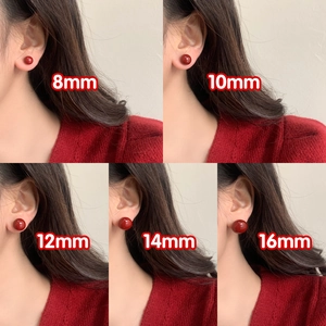 Size comparison of red pearl earrings in 8mm to 16mm diameters on ear model
