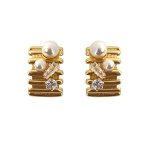 Elegant gold striped stud earrings with pearls and crystals on a clean white background