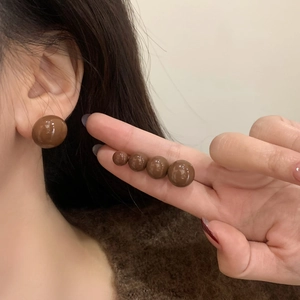 Brown round resin stud earrings with high polish finish in five various sizes