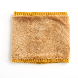 Detailed view of yellow knitted neck warmer with thick brown faux fur lining texture