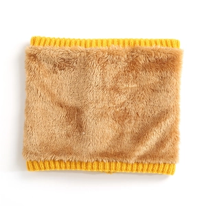 Detail of winter neck warmer showing yellow knit trim and thick brown faux fur texture