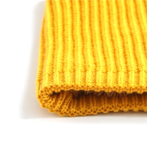 Close-up of bright yellow ribbed knit scarf with thick warm brown fleece lining detail