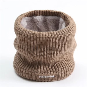 Detail of brown chunky knit neck warmer with thick plush lining and white embroidery