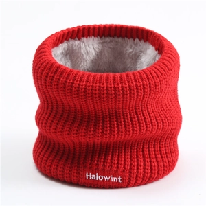 Detail of red knitted winter scarf showing warm gray fleece lining and white embroidery