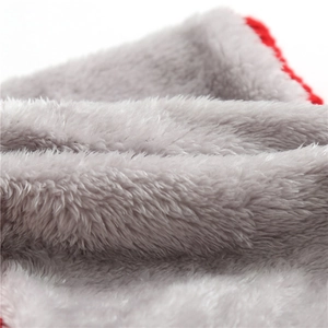 Macro view of soft grey fleece lining with red stitched edge on thermal winter scarf