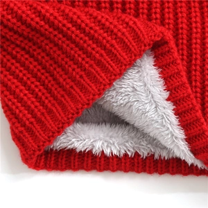 Close-up of red winter knit infinity scarf showing warm gray faux cashmere lining
