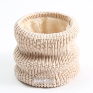 Detail of beige knitted neck warmer with thick fleece lining and white logo embroidery