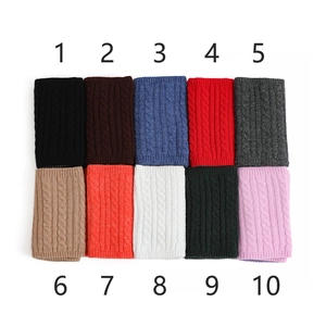Dettaglio di sciarpe in maglia a trecce disponibili in 10 diversi colori vivaci