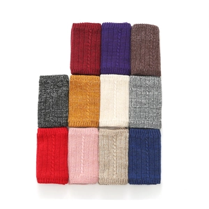 Macro detail of various colors and knit cable texture on winter warming neck gaiters