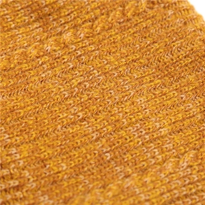 Macro detail of mustard yellow knit fabric with thick chunky texture and warm fleece lining