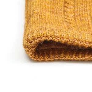 Close-up of ginger yellow chunky knit neck warmer showing thick ribbed texture and fleece