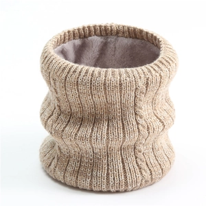 Close-up of thick knitted infinity scarf showing beige ribbed texture and grey fleece lining