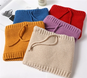 Detail of knitted neck warmers in five colors with drawstring and thick cable knit texture