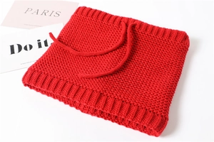 Close-up of red knitted neck warmer with drawstring detail and thick rib texture