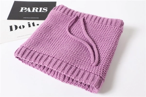 Macro detail of purple ribbed knit neck warmer with soft braided drawstring texture