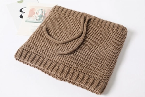 Detailed texture of brown knitted neck warmer with drawstring and ribbed edges