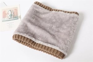 Close-up of winter knitted neck warmer with thick brown texture and soft grey fleece lining