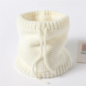 Detail of cream knitted neck warmer showing thick fleece lining and adjustable drawstring
