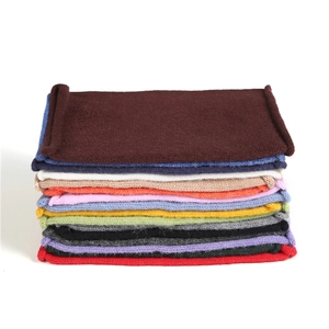 Vertical stack of multi-color knitted neck gaiters showing various candy colors and textures