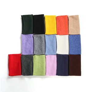 Close-up of 16-color knit neck warmer collection showing diverse textures and vibrant tones