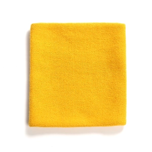 Close-up of bright yellow ribbed knit texture on a soft winter neck warmer scarf