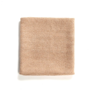 Flat lay close-up of light brown knit snood showing fine stitch texture and soft fabric