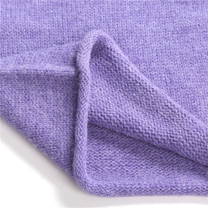 Detail of soft lavender knitted fabric showing smooth texture and clean stitched edges