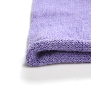 Close-up of the fine knitting texture and rolled edge of the soft purple scarf