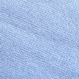 Detail of light blue knitted fabric showing neat V-shaped stitches and soft wool texture