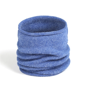 Macro shot of blue knitted neck warmer showing ribbed texture and seamless edges