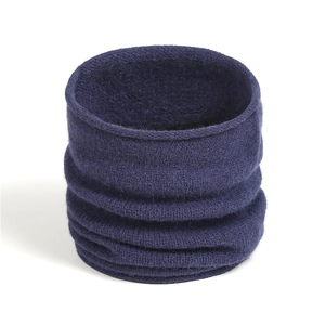 Detail of soft dark blue knitted neck gaiter with textured ribbed fabric and pleated style