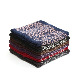 Details der Strickstruktur von Winter-Halswärmern mit nordischen Schneeflockenmustern in sechs Farben
